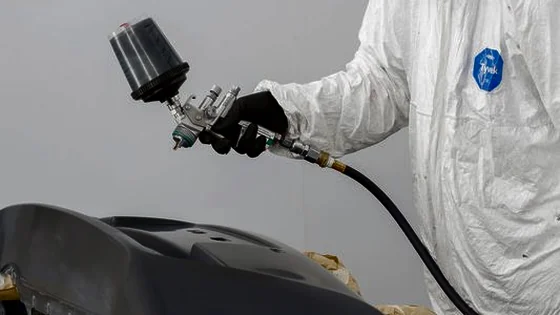 A panel being prepared for paint in a body shop.